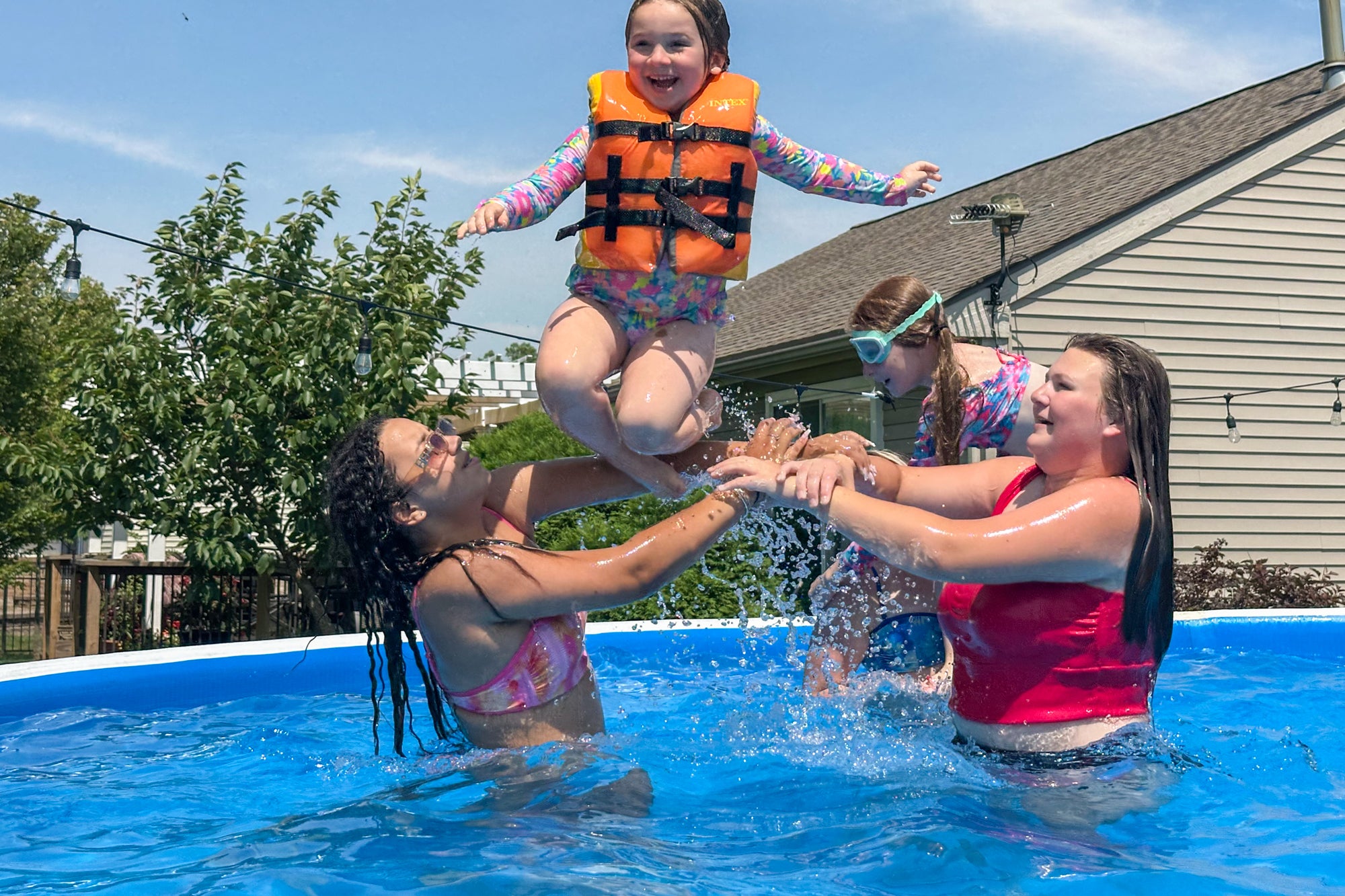 Family enjoying their backyard pool